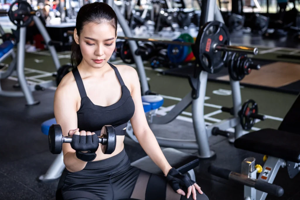woman holding dumbbell in the gym